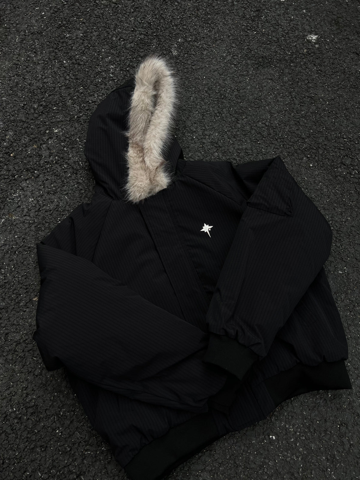 BLACK ENERGY CROSS EMBLEM FUR HOOD JACKET; Black; front view in a styled setting
