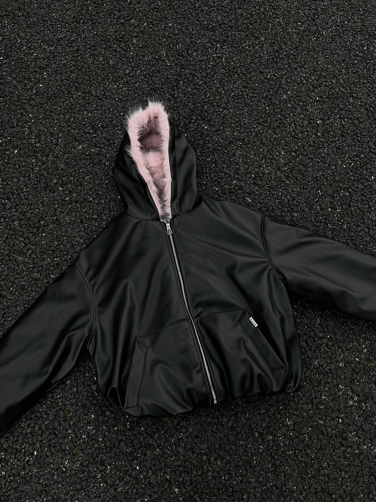 BLACK ENERGY PINK FUR TRIM JACKET; Black; front view in a styled setting