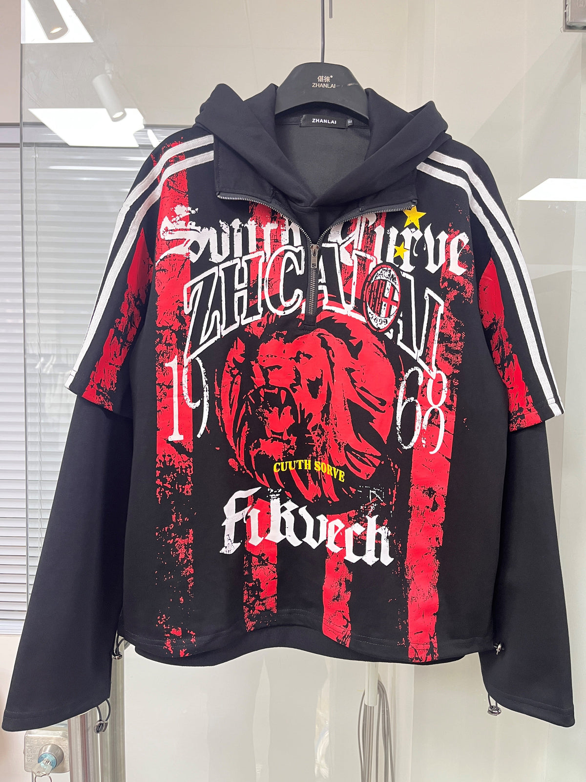 ZHANLAI LION DRAGON GRAPHIC HOODIE; Black; front view in a styled setting