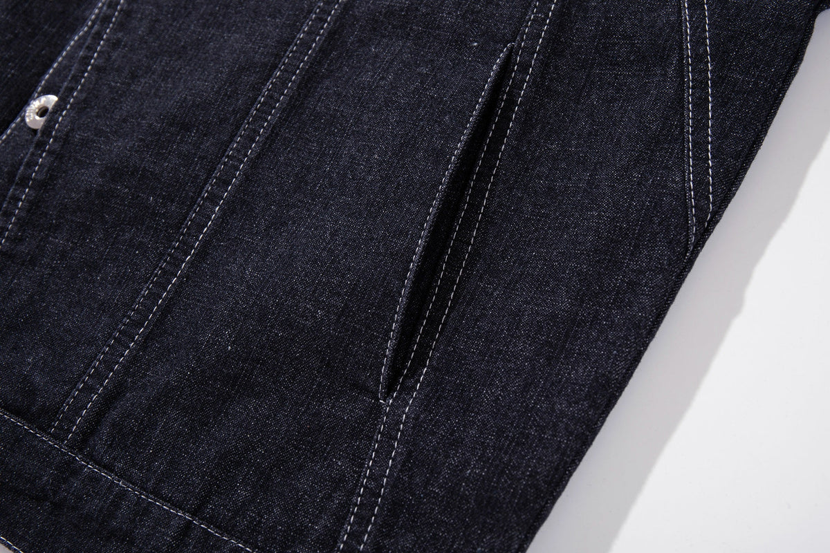MCCNN ASYMMETRIC CONTRAST STITCH TRUCKER JACKET; Black; garment construction detail