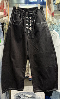 UNF BUTTON RAW BAGGY BARREL JEANS; Black; front view in a styled setting