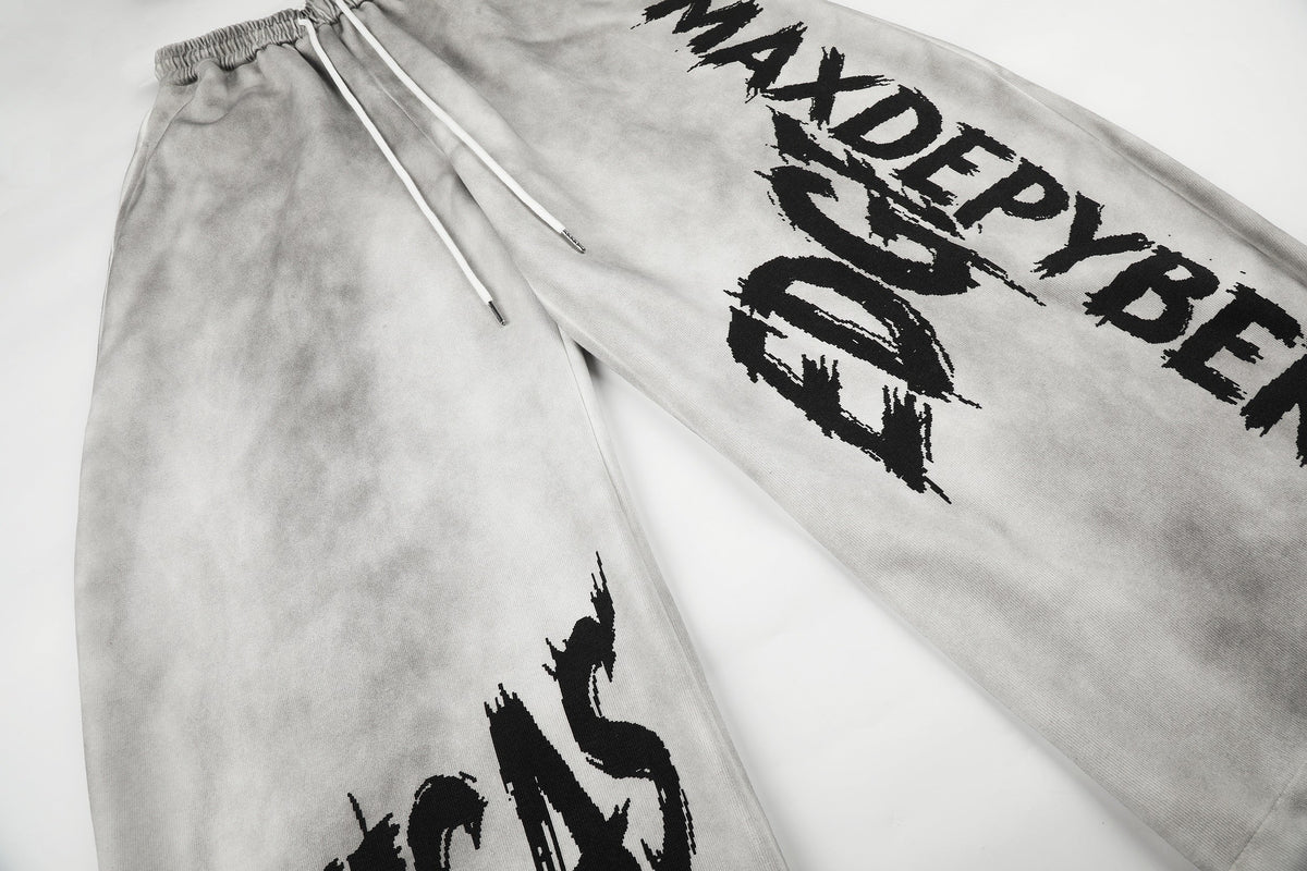 GEESAS DIAGONAL LETTER GRAPHIC SWEATPANTS; Gray; design detail