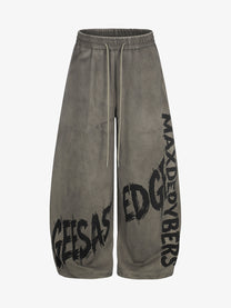 GEESAS DIAGONAL LETTER GRAPHIC SWEATPANTS; Brown; front view