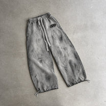 GUO WEAR WASHED CURVED LEG SWEATPANTS; Gray; front view in a styled setting