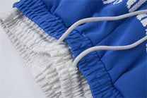LETS ROCK CROSS SPRAY GRAPHIC SWEATPANTS; Blue; garment construction detail