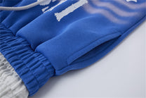 LETS ROCK CROSS SPRAY GRAPHIC SWEATPANTS; Blue; garment construction detail