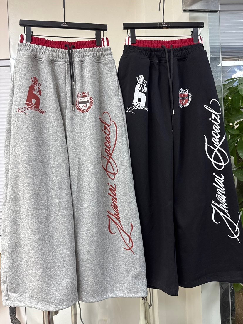 ZHANLAI RACING CREST GRAPHIC SWEATPANTS; Black, Gray; multiple colorways shown together