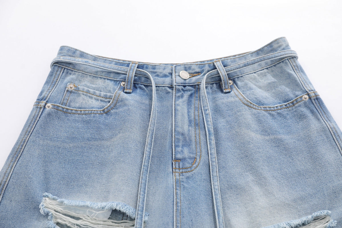 BLANKIN DISTRESSED RAW EDGE JORTS; Blue; garment construction detail