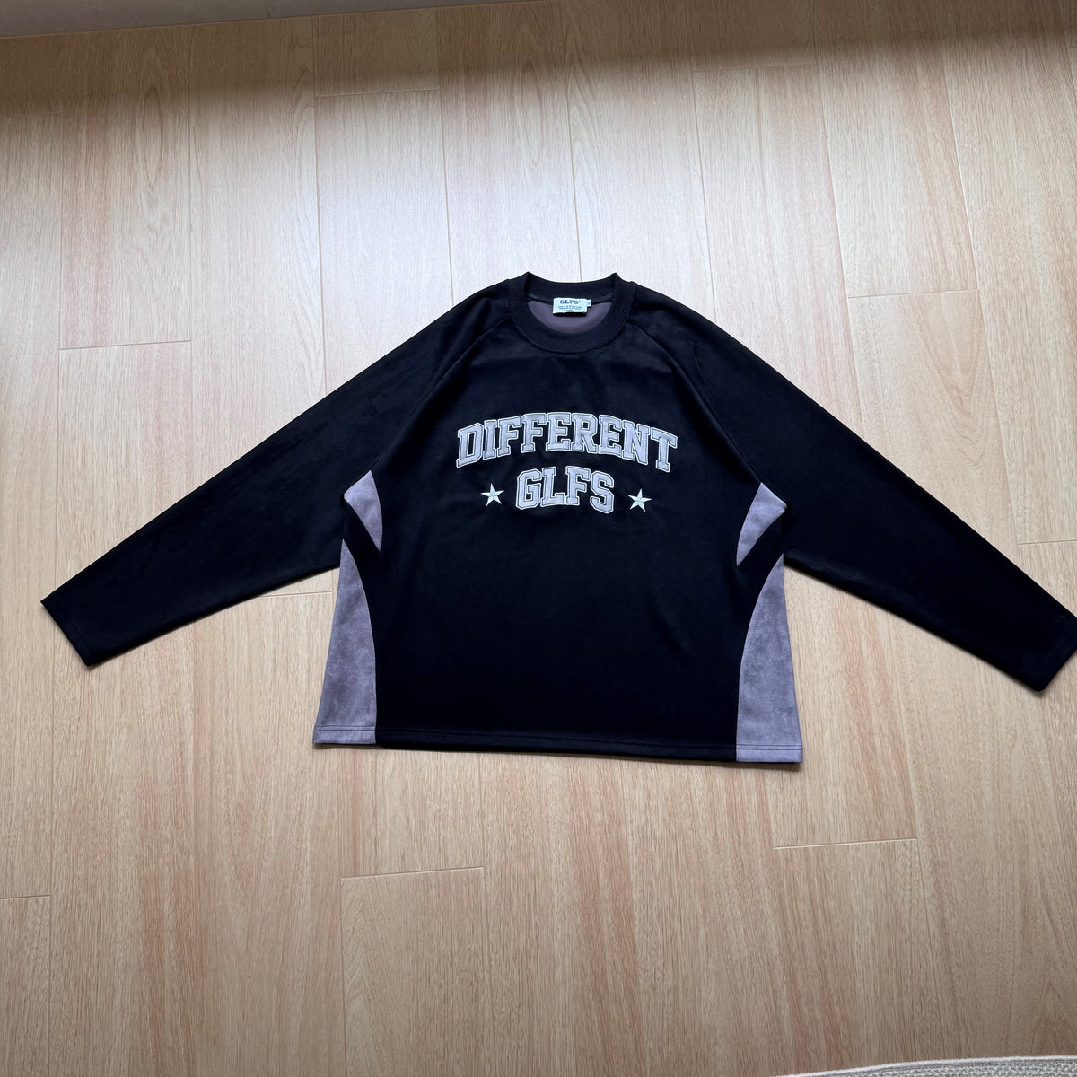 GLFS DIFFERENT LETTER GRAPHIC SWEATSHIRT; Black; front view in a styled setting