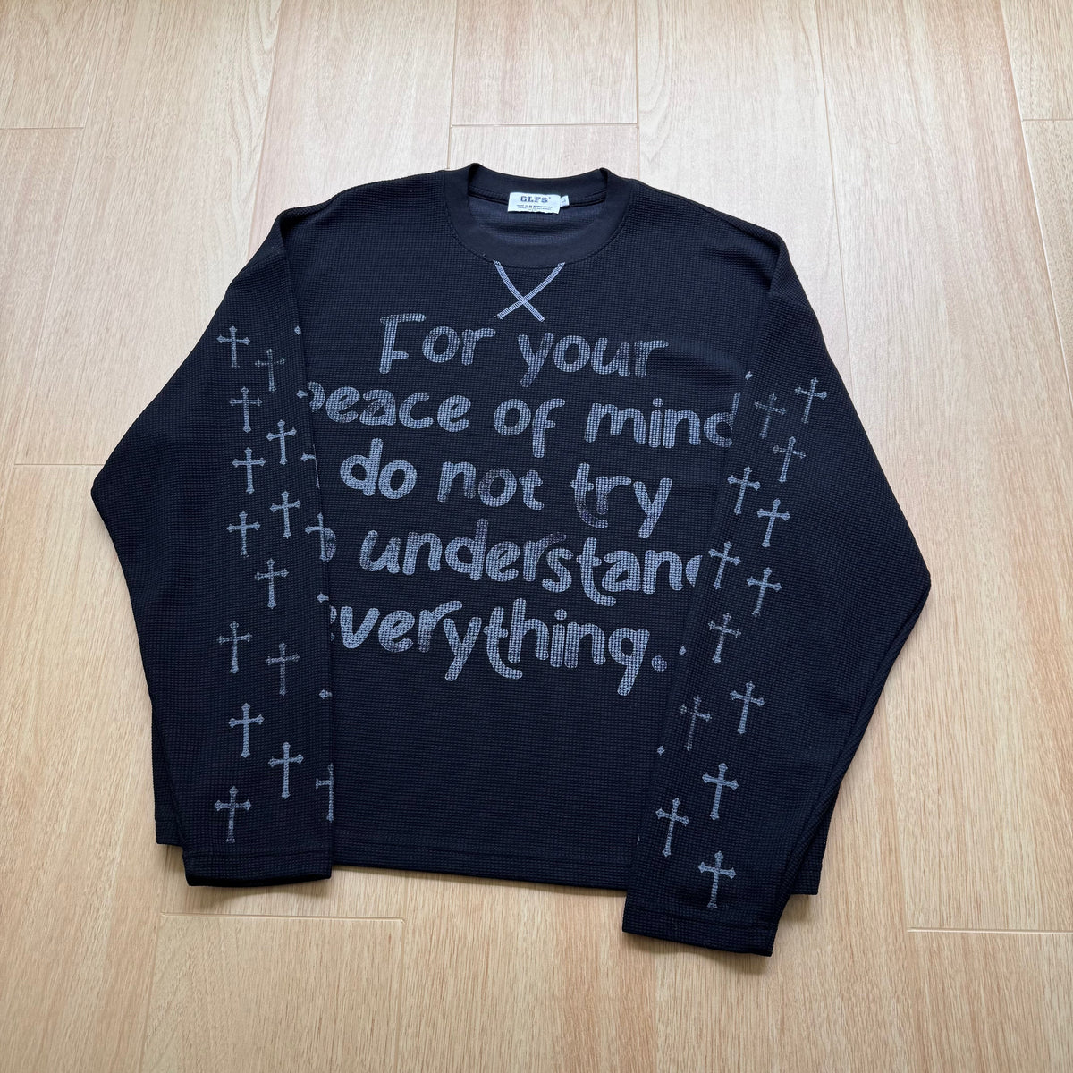 GLFS CROSS SLEEVE SLOGAN SWEATSHIRT; Black; front view in a styled setting