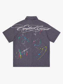 SAVAGE BASE | Paint Splatter Script Plaid Shirt in Black - back view